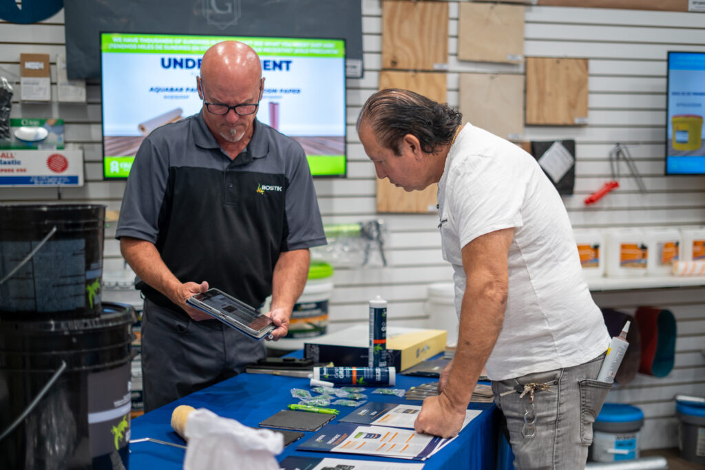 Bostik representative helping customer at Old Master Products showroom in Van Nuys, CA